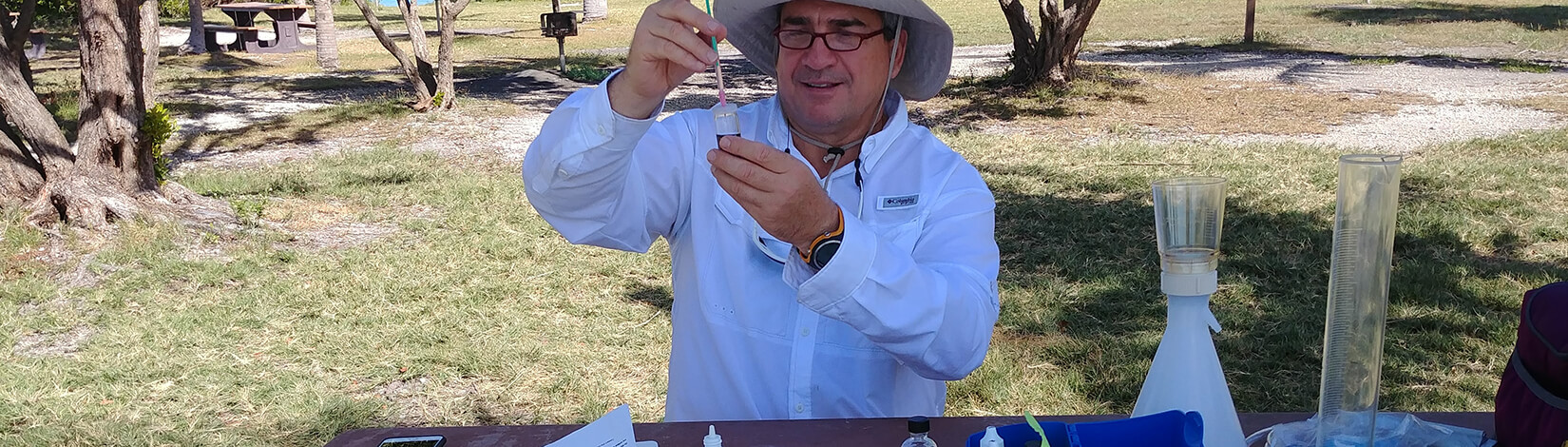 Photo of a Water Watch volunteer testing a sample of water