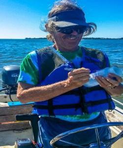 Nature Coast Water Watch volunteer Joe Hand labeling a sample bottle. (Photo: Lisa Custer)