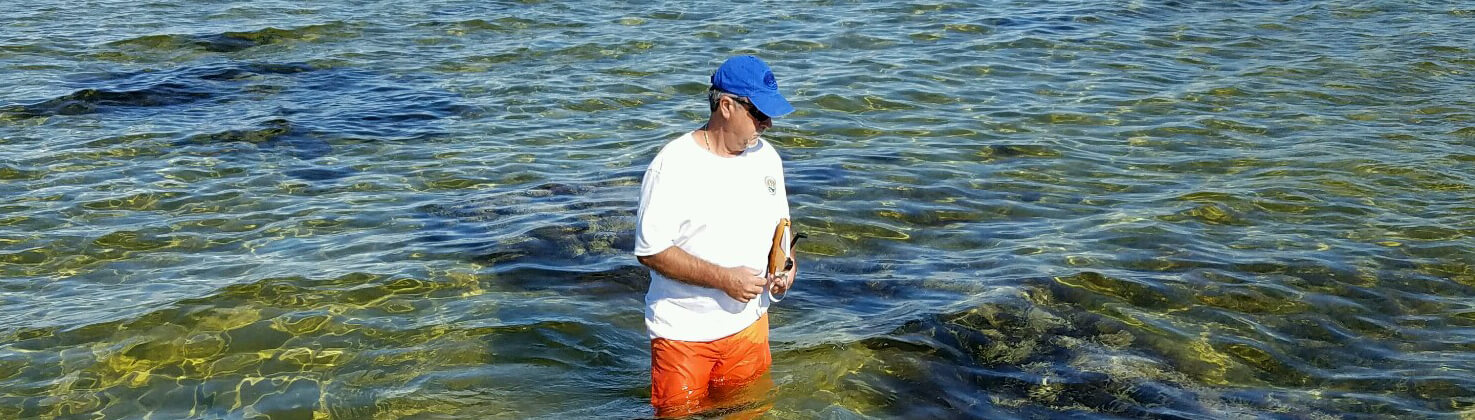 photo of a water watch volunteer wading while collecting a sample